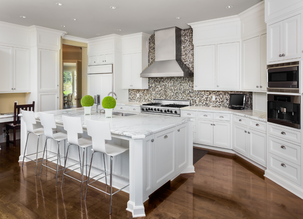 Renovated kitchen with updated cabinetry, lighting and finishes